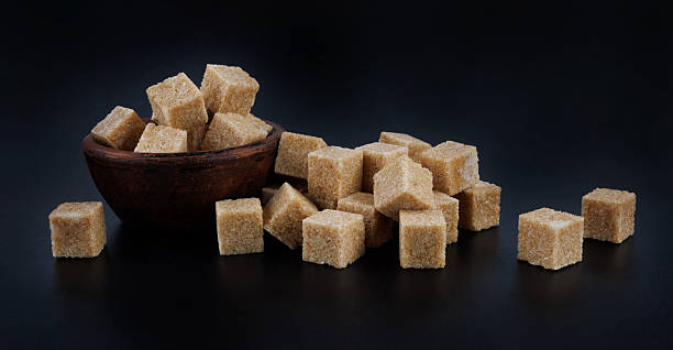 Clay cup with brown sugar cubes. Cane brown sugar.