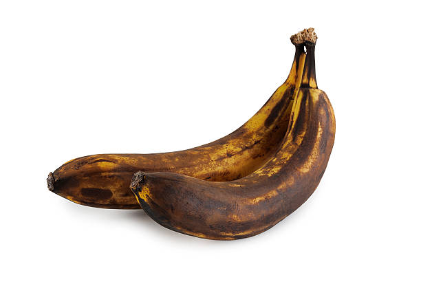 istock Two overripe bananas with blackened peel isolated on white background. 2259819965