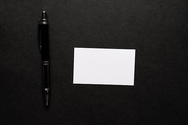 A note and ballpoint pen on a black background
