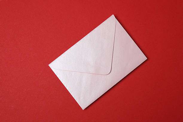 Happy Valentine's Day. Envelope with greeting card and decorative heart on red background, top view