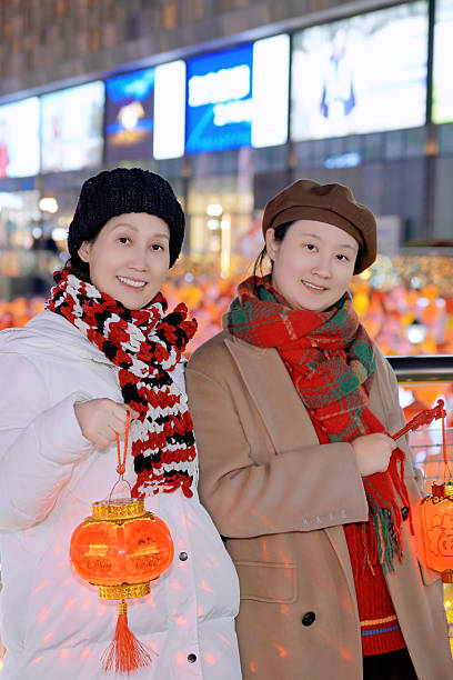 Two Women with Red Lanterns in City Nightscape