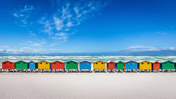Muizenberg Beach Huts. Colorful Panorama of the famous vibrant beach huts on the white sandy beach of Muizenberg, Cape Town, South Africa.