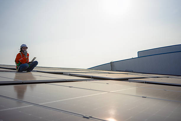 istock Blue collar worker is inspecting solar panel at rooftop of factory. 2259827179