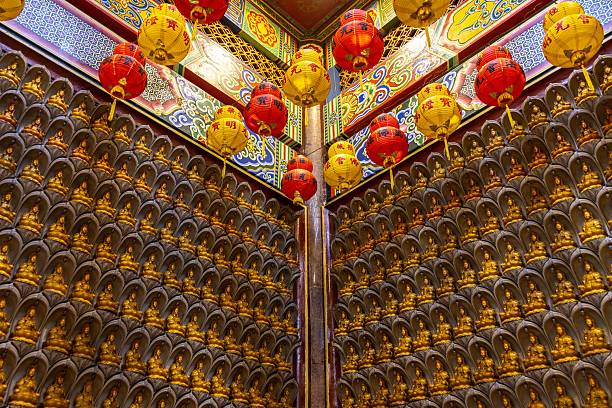 The interior decoration by small Buddha sculptures in Chinese temple.