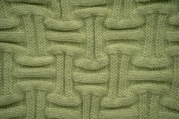 Basketweave Knitted Fabric wool sweater texture green background.