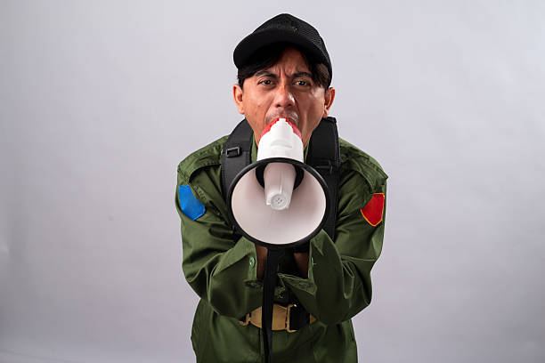 Caucasian man in camouflaged army uniform crossing arms