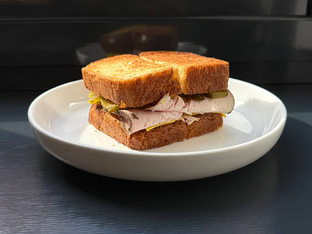 Grilled Turkey Pastrami Sandwich with Pickles and Cheese. Quick Breakfast Concept. Handmade Phone Photo, Selective Focus, Non AI