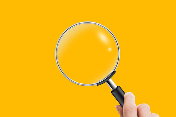 Woman hand holding magnifying glass on white background