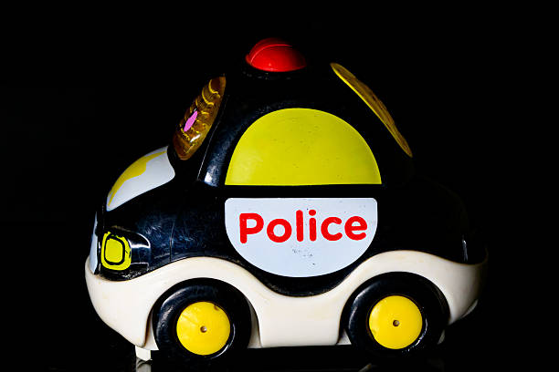 Police car toy on a black background