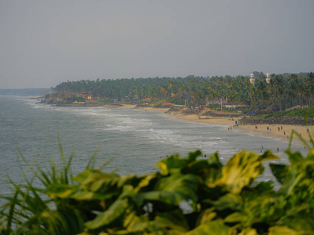 Distant view of people enjoying beautiful Varkala beach in Kerala, India