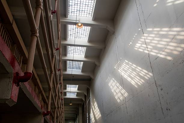 A long exposure of the inside cell blocks of alcatraz prison, san francisco, california. Motion blur is of tourists who are visiting the prison. Many famous prisoners were locked up in this historic site, one of the most popular tourist attractions in San Francisco, California. Image taken with Canon 5D camera body and L series lens. 