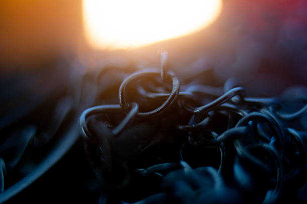 Photograph of ritualistic chains lit by candlelight.