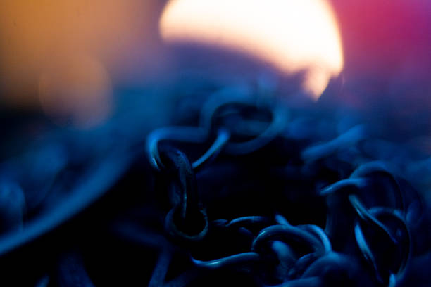 Photograph of ritualistic chains lit by candlelight.