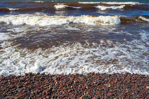 Colorful pebbles on shore of Lake Superior at Presque Isle River Falls Loop in Porcupine Mountains, Michigan, USA