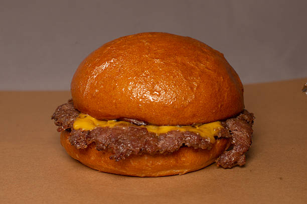 Closeup Of Charred Beef Patty With Melted Cheese And Intense Flavor