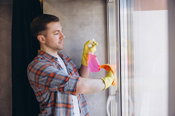 istock Man Cleaning Windows at Home wearing Protective Gloves 2259861888