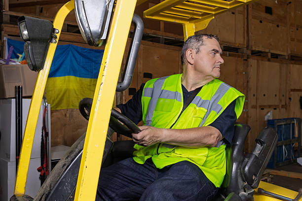 Blurred Warehouse Space for Logistics Industry. Forklift Loading a Package Boxes. Storage Warehouse. Supply Chain Shipment Goods. Distribution Warehouse Shipping Logistics.