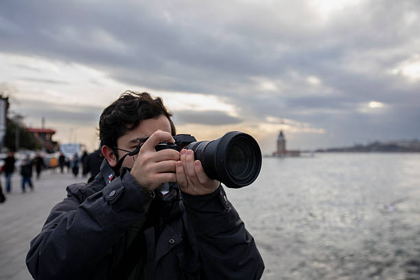 Professional digital photo camera with zoom lens on black background