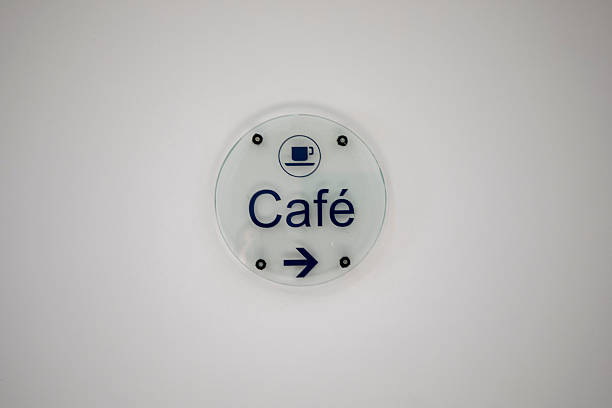 Red and white team room sign, 183.1, with braille code on a white interior building wall.