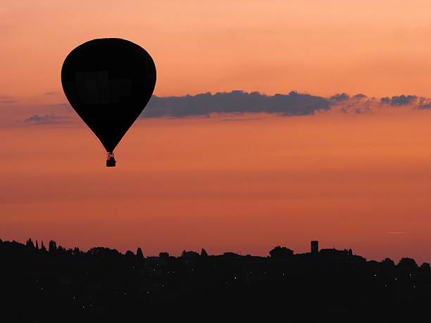Umbria, Italy:Hot air balloon in flight at dawn