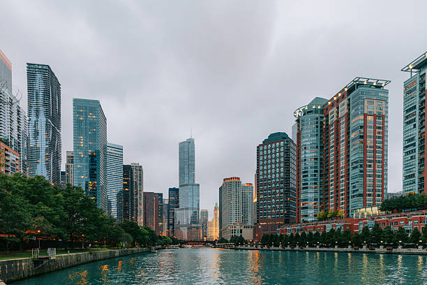 The Chicago skyline reflects softly on the river’s surface, creating a balanced and calm urban scene at twilight.