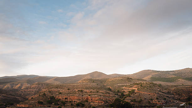 Wide landscape view of mountains under a soft sky, representing rural scenery, nature, travel destinations, and peaceful environments.