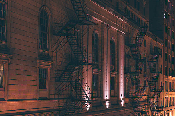 Warm lighting reveals architectural details on a historic Chicago building, blending heritage with the surrounding city at night.