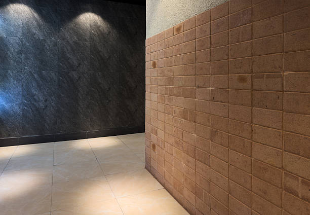 A contemporary interior space featuring textured walls and warm lighting, creating an inviting atmosphere. The scene highlights architectural elements and design aesthetics suitable for modern settings.