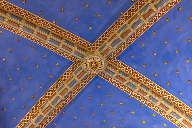 Decorative ceiling in an ancient basilica featuring rib vaults and golden stars