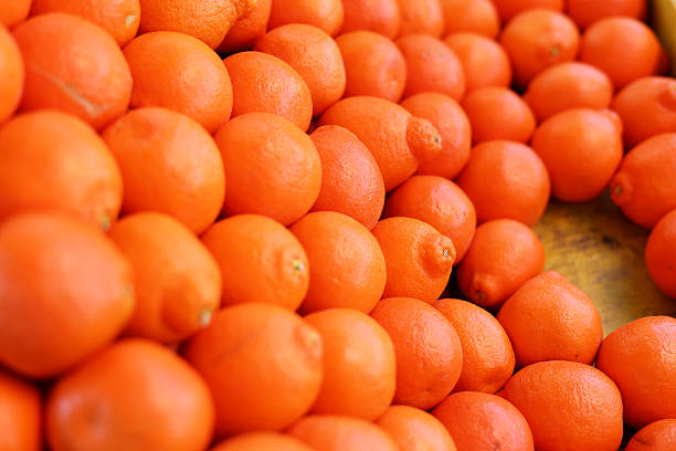 A close up view of many oranges piled up