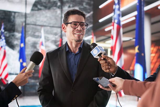 Close up of a microphone at a business conference, people in background