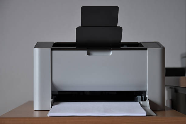Front view of laser printer against white wall