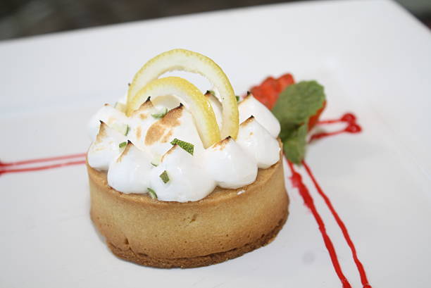 Gourmet Lemon Meringue Tart with Toasted Peaks and Fresh Garnishes
