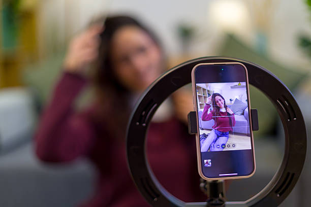istock Young woman vlogging with smartphone and ring light 2259930689