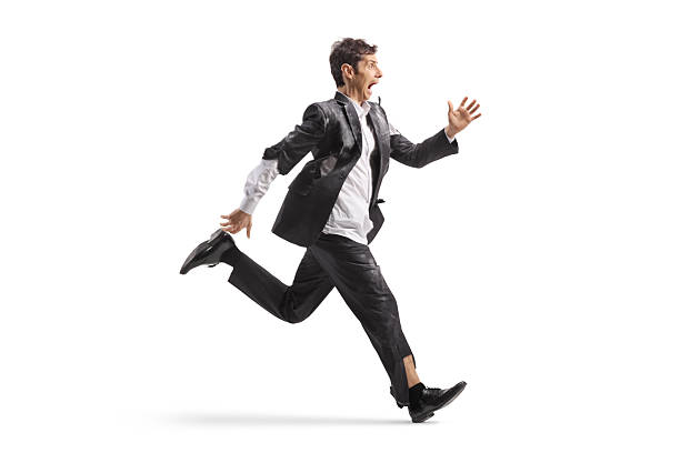 Scared man in a ripped suit runs in panic isolated on white background