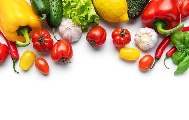 Fresh vibrant farm vegetables forming border on white