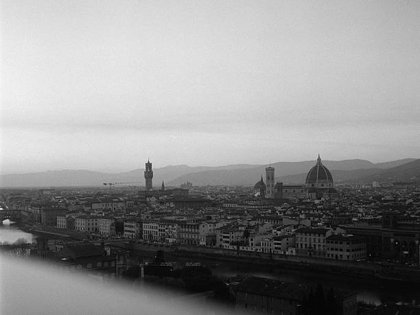 Florence iconic skyline capturing the Duomo, Palazzo Vecchio, and Arno River, on a cloudy day in Italy. Scanned from analog film