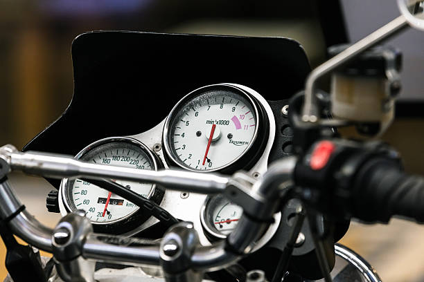 St.Petersburg, Russia - December 1, 2024: White analog Triumph sport bike dashboard with speedometer, tachometer, odometer and fuel indicator and company logotype
