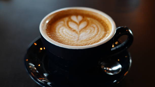 Warm Coffee with Heart Latte Art on a Dark Table