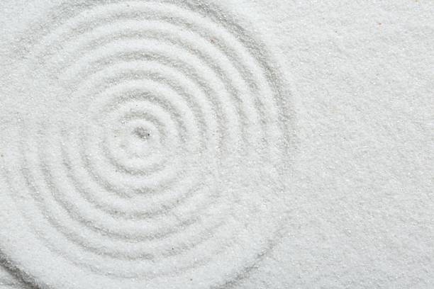 istock Zen rock garden. Circle pattern on white sand, top view. Space for text 2259995001