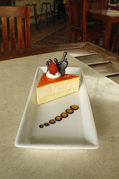 Gourmet Cheesecake Slice with Strawberry, Whipped Cream, and Chocolate Art