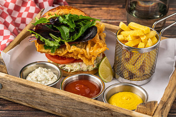 Crispy fried chicken burger served with fries and creamy dips