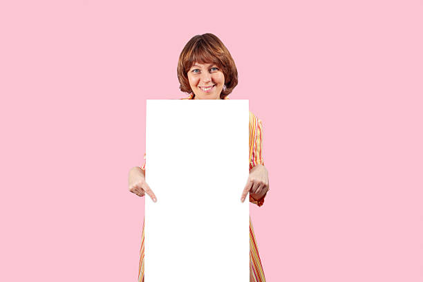 Photo of pretty satisfied girl stand behind empty space blank cover body isolated on blue color background.
