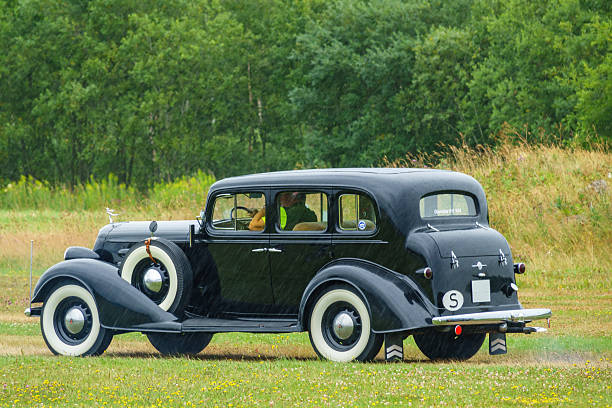 Falköping, Sweden-July, 2023:Black Oldsmobile from 1934 driving in rainy weather