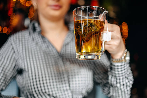 Young woman enjoying at cafe having a hot tea