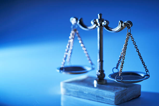 Ray on libra scale against blue background