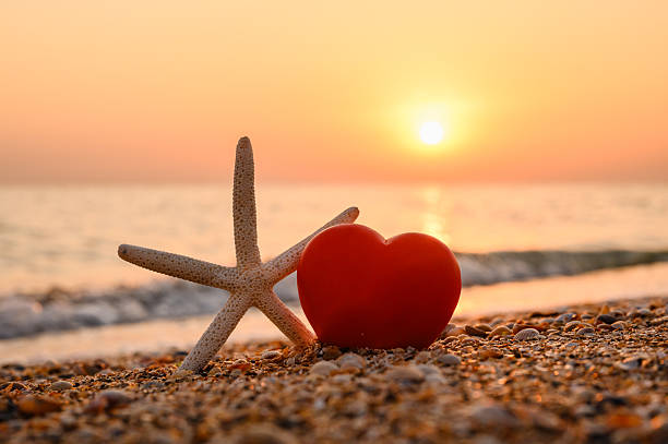 A warm seaside sunset. A romantic postcard with a heart by the sea.
