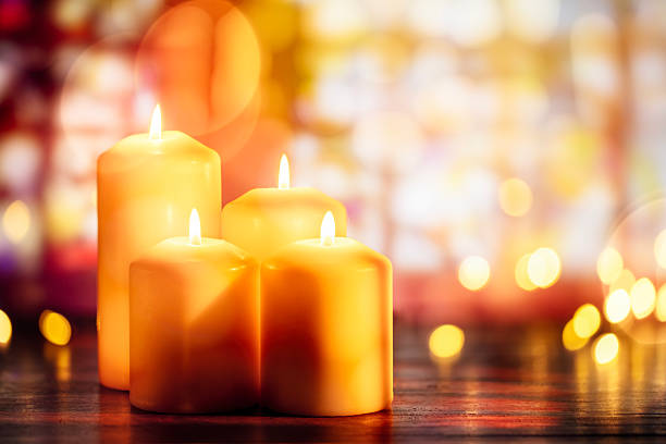 Candles burning in a church background