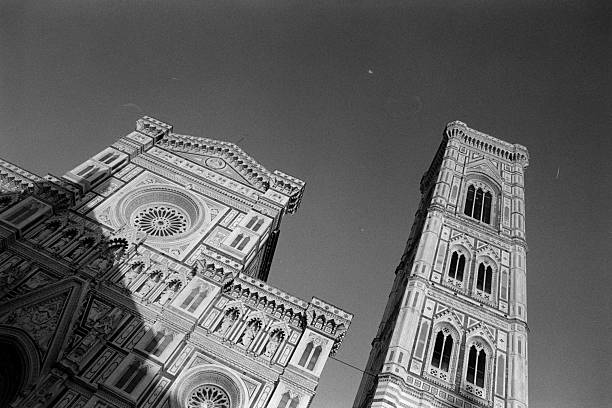 Florence Cathedral and Giotto's Bell Tower featuring intricate Gothic architecture in black and white against a vast clear sky. Scanned from analog film