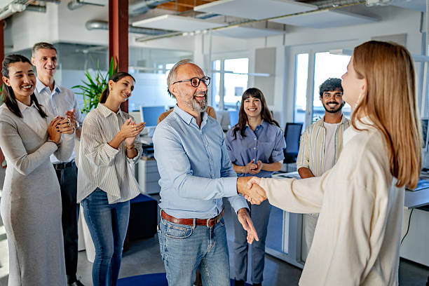 istock People in a modern office in Berlin engage during a warm greeting and show support for a colleague in a coworking space 2260031336